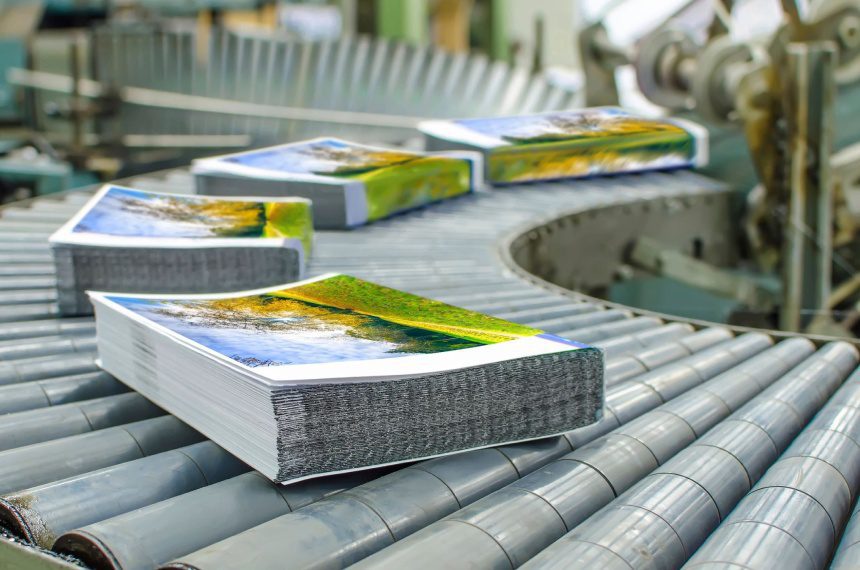 A conveyor belt with several books on it.